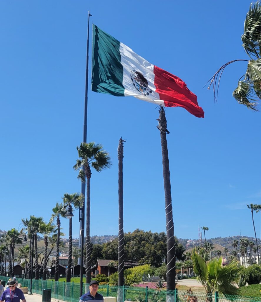 The Mexican flag moves with the coastal breeze above the wharf, a steady symbol of the place my kids are growing up and learning to navigate two languages and two worlds while raising bilingual kids in Mexico.