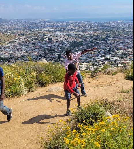 Parent connecting with children during an outdoor activity that supports speech and communication.