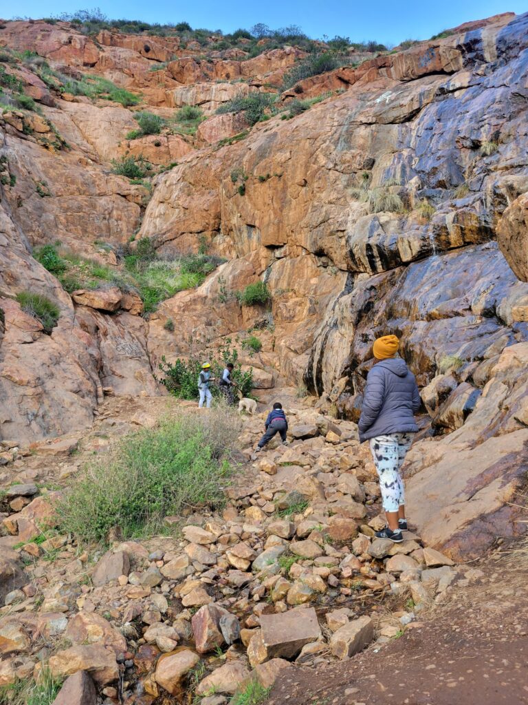 Kids climbing and exploring rocks during a family nature walk that sparks curiosity and creative play