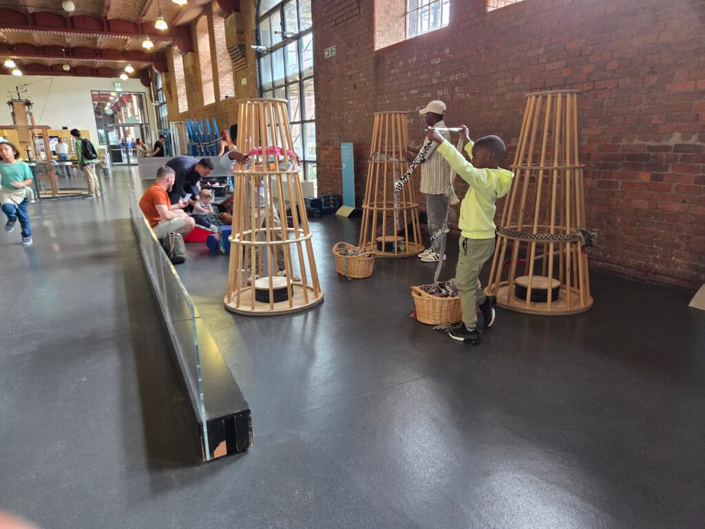 Kids playing museum exhibits and experimenting with different ways to figure things out