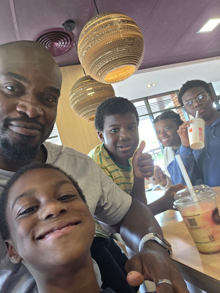 Father spending time with his children, reflecting the values to teach your children through everyday family moments.