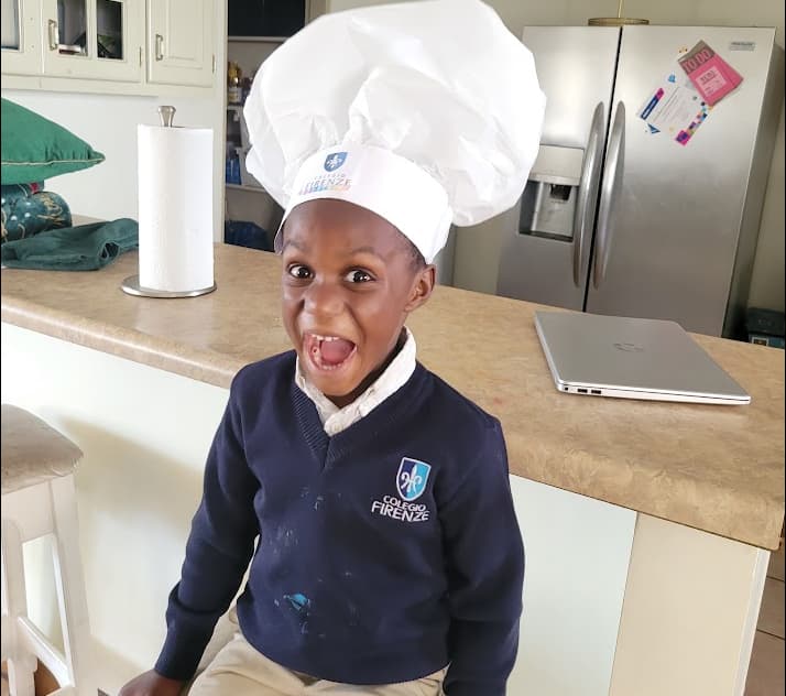 Young boy practicing communication skills through everyday activities at home
